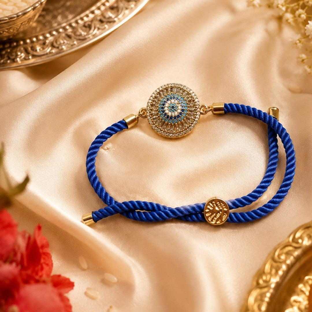 Kallos Jewellery premium blue bracelet Rakhi featuring a central evil eye design with sparkling AD zircon stones.